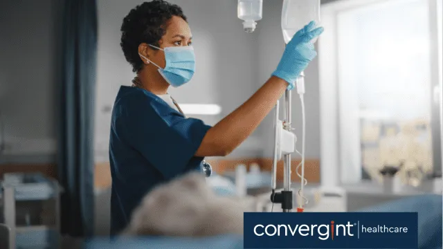 Female nurse checking on patient in hospital