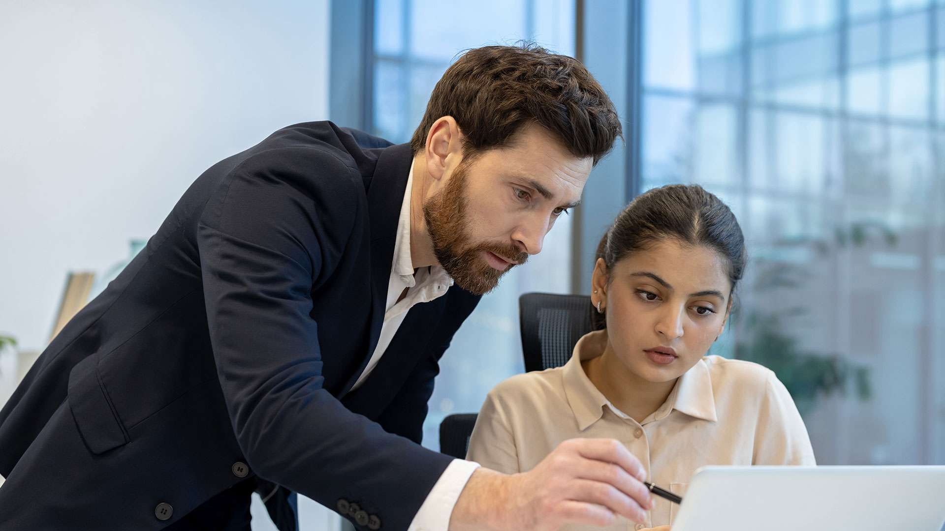 Man explaining information on a sheet of paper to his co-worker.