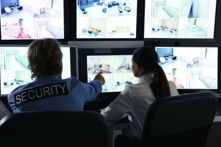 Security team watching surveillance monitors