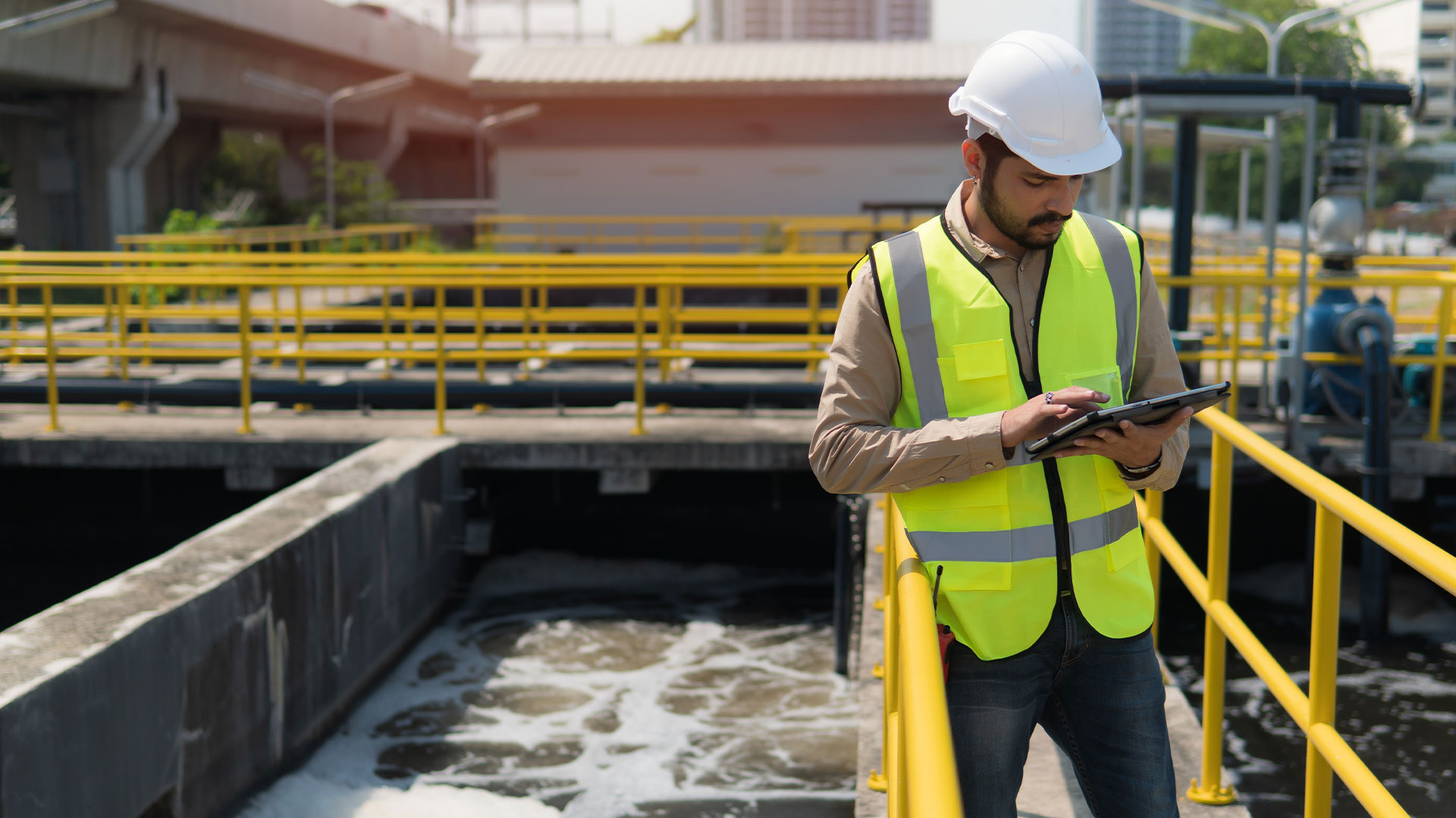 worker checking iPad at water treatment facility