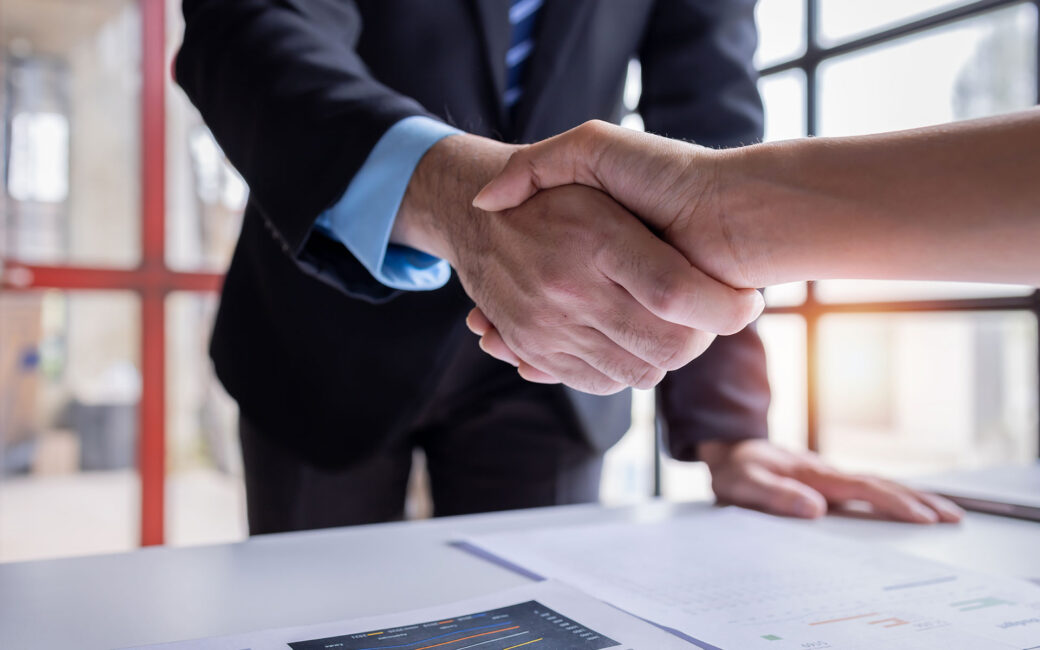 Handshake of businesspeople. Female and male hand makes a handshake in the office.