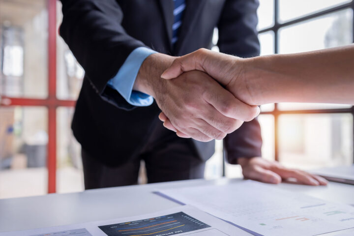 Handshake of businesspeople. Female and male hand makes a handshake in the office.