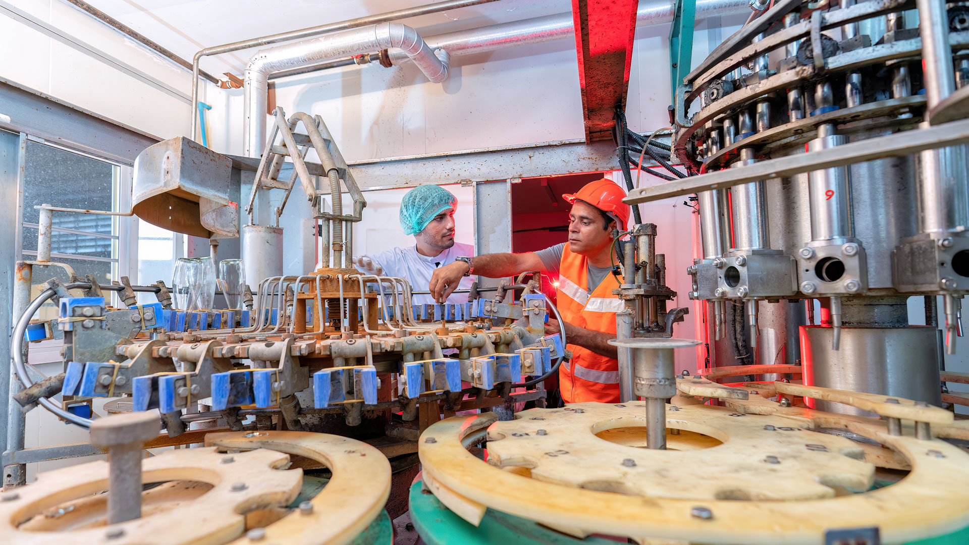 Beverage worker in drink factory found machine breakdown and inform to service team for repair