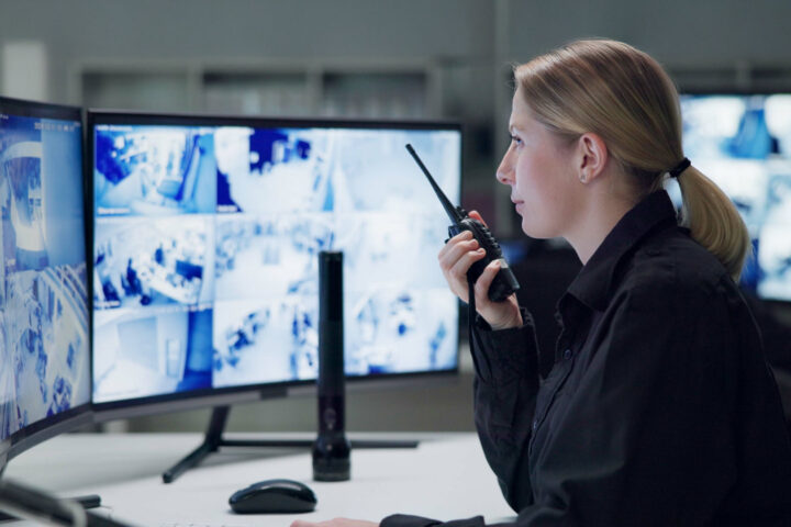 Watch, security and woman with radio, cctv and monitor for danger, talking and control room for gua