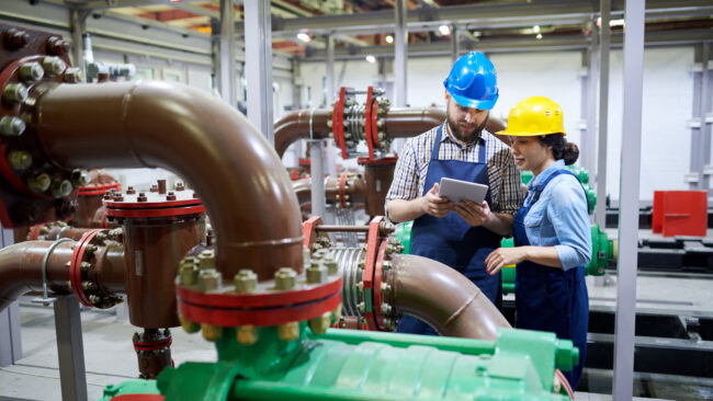 Two engineers in a water treatment facility