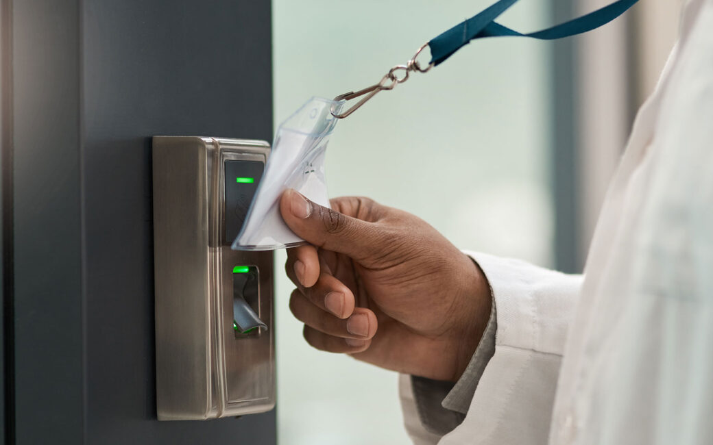 Closeup shot of a physician using an access card to gain entry at a door