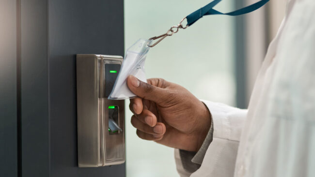 Closeup shot of a physician using an access card to gain entry at a door