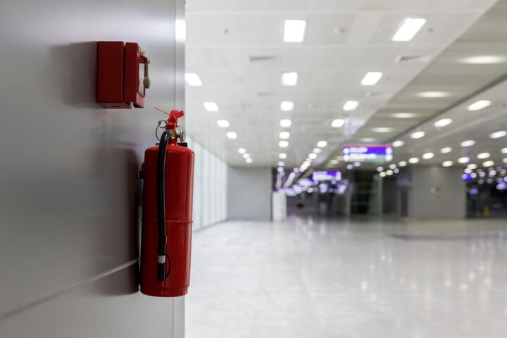 Dry chemical powder fire extinguisher in corridor